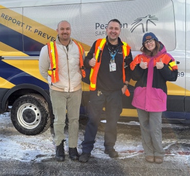 a group of people posing for a photo in front of a bus