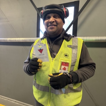 a man wearing a safety vest and a helmet