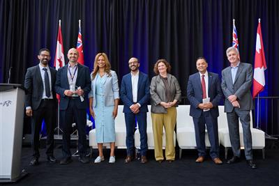 a group of people standing on a stage with flags behind them