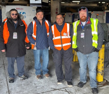 a group of men wearing safety vests