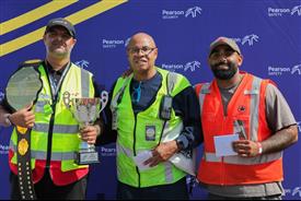 a group of men holding trophies
