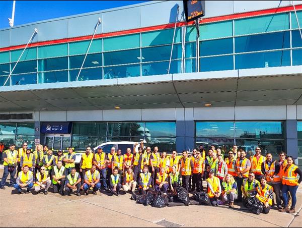 a group of people in yellow shirts posing for a photo
