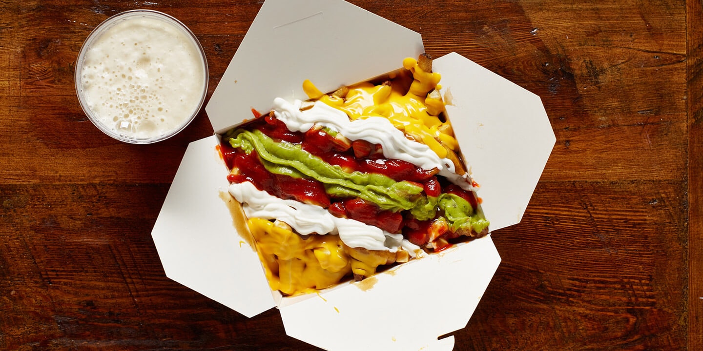 Vegetarian poutine with colourful sauces