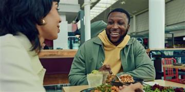 a man and a woman eating food