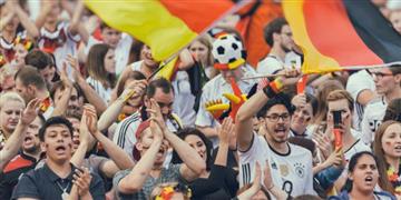 a crowd of people holding flags