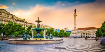a fountain with a statue in the middle of a courtyard with buildings