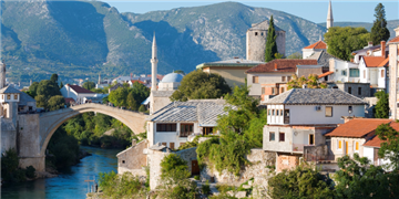 a bridge over a river with buildings and a bridge