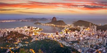 a city with a body of water in the background