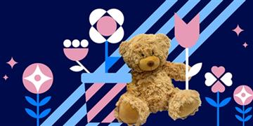 a teddy bear holding a flag