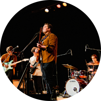 a group of people playing instruments on a stage