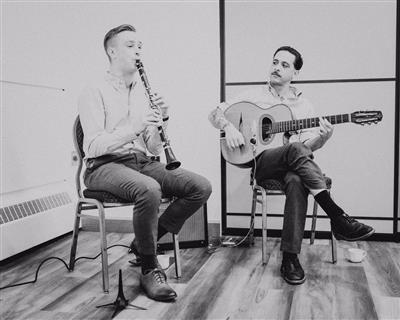 a couple of men playing guitars