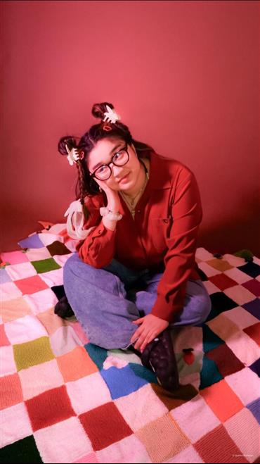 a woman sitting on a bed