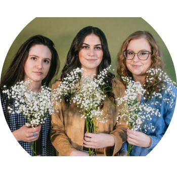 a group of women holding flowers