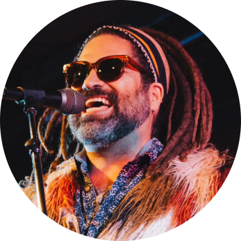 a man with sunglasses singing into a microphone