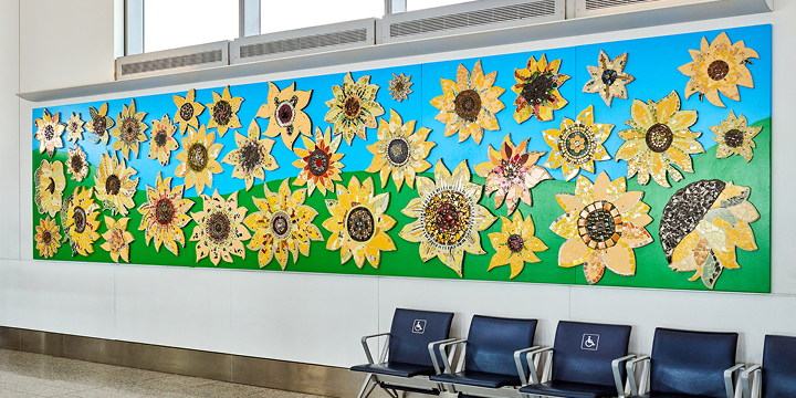a wall with chairs and a wall with a mural of sunflowers