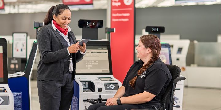 a woman showing a man something on the computer