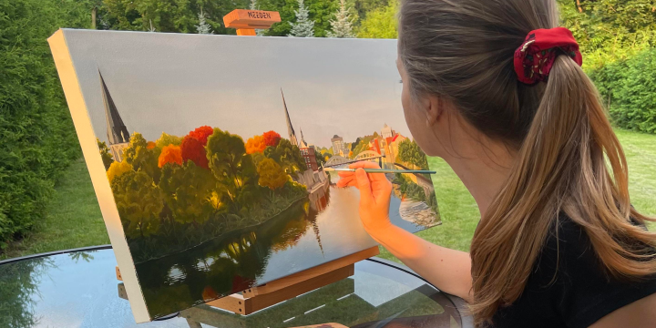a woman looking at a painting
