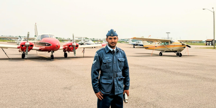 a man standing in front of airplanes