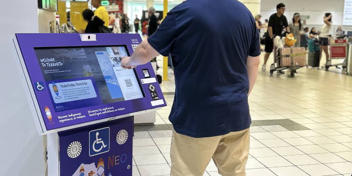 a man standing next to a display