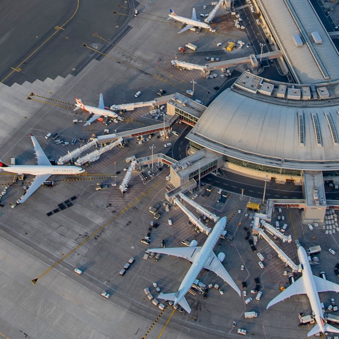 a group of airplanes in a large airport
