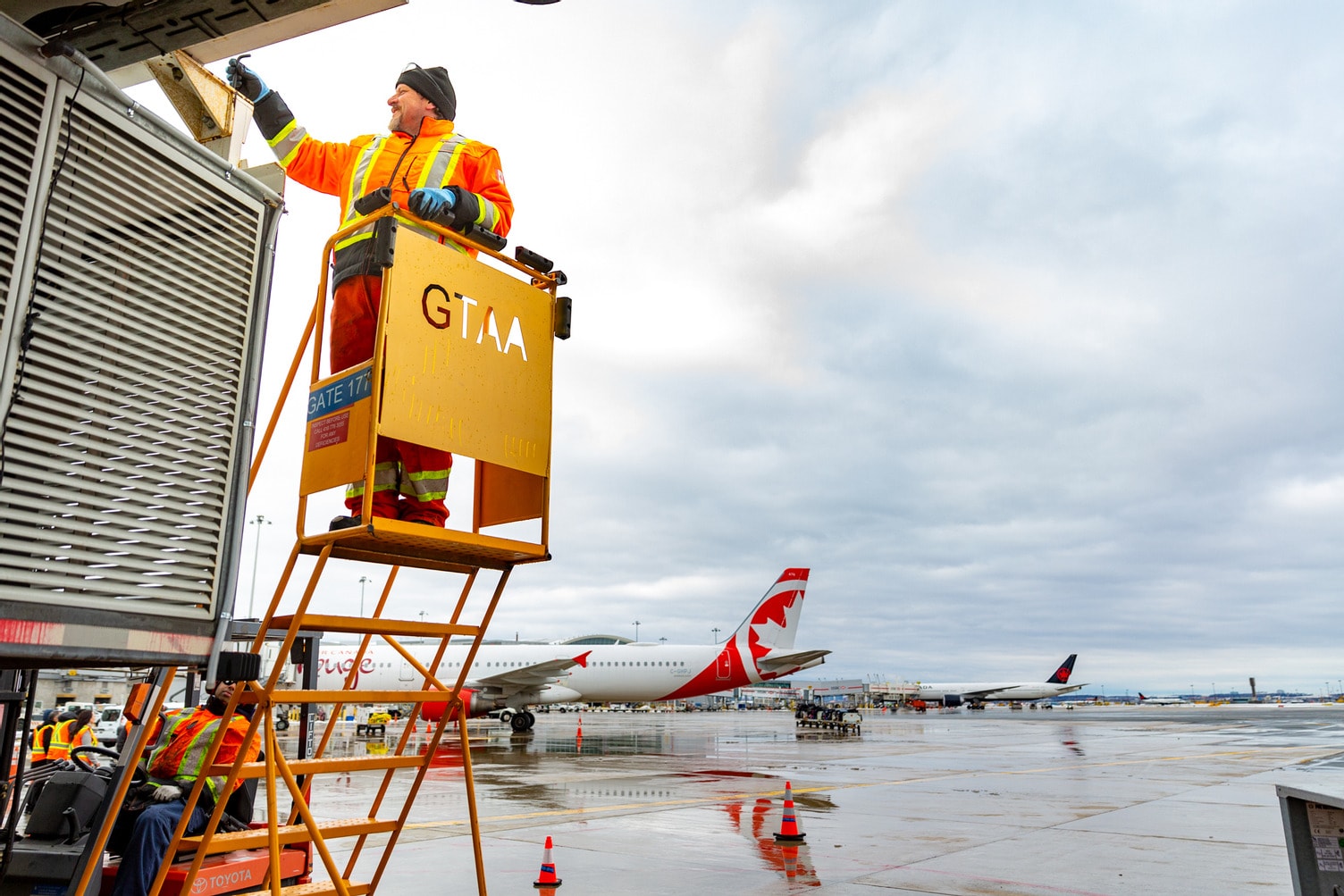 a person on a ladder working on an airplane