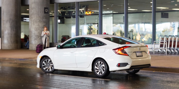 a white car parked outside a building