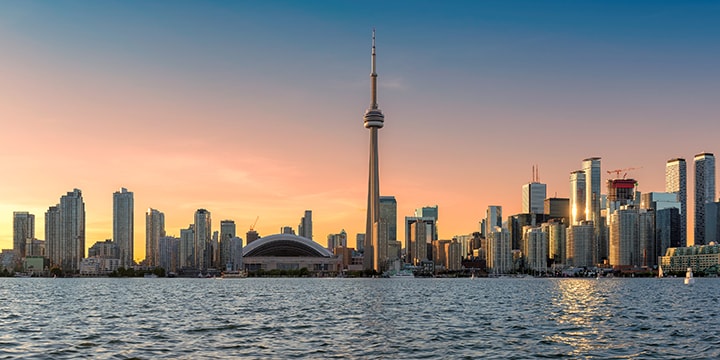 a city skyline with a body of water in the foreground