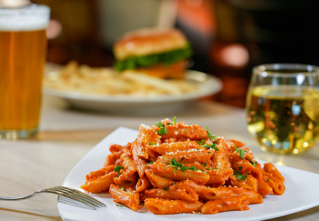 a plate of pasta and a glass of beer