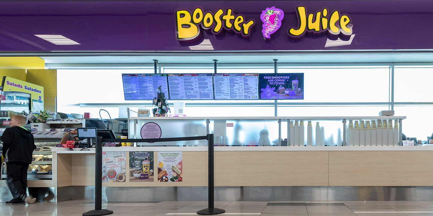 Booster Juice counter with menu and sign.