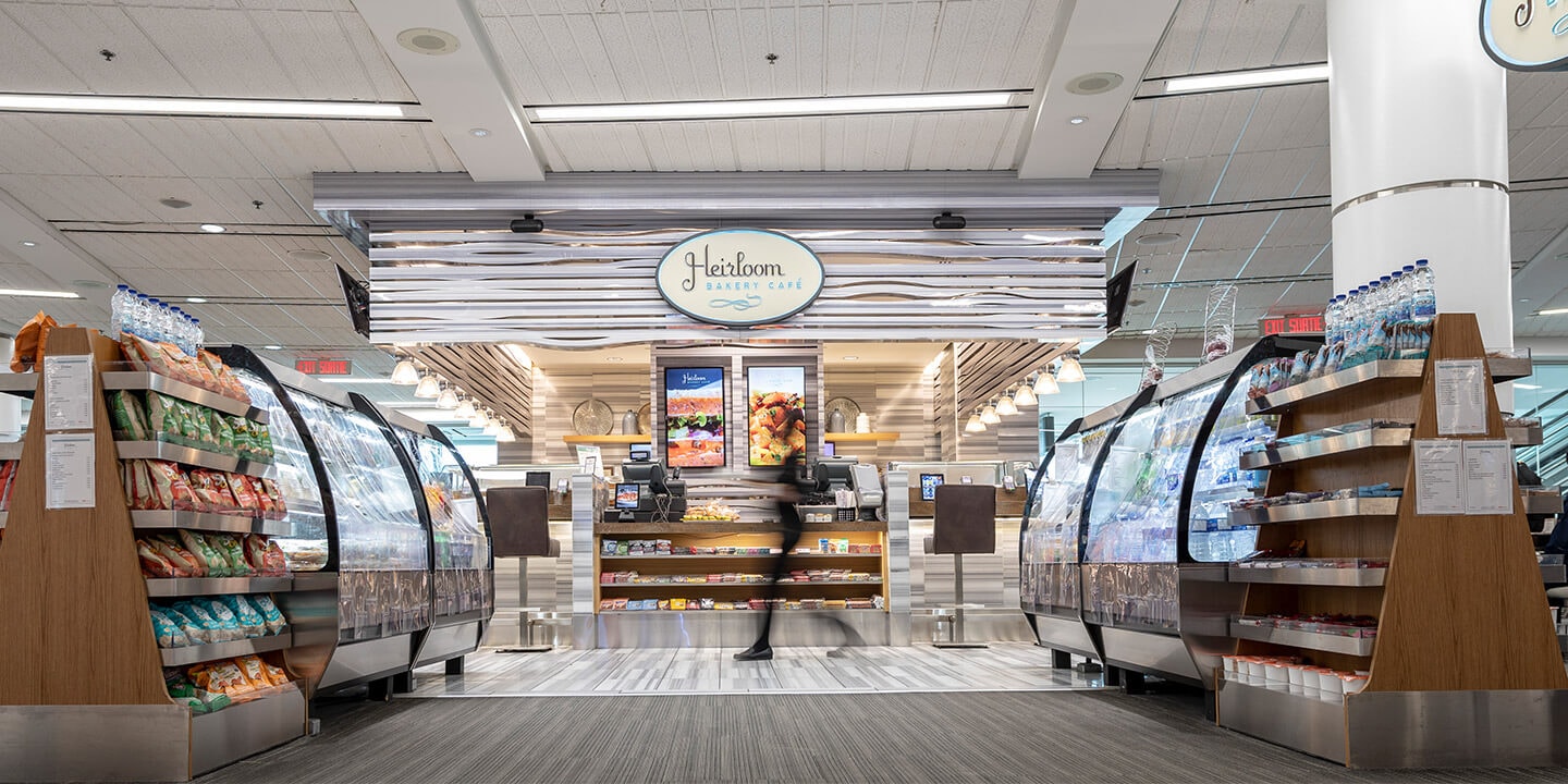 Heirloom sign above counter with grab-and-go snack cases on either side