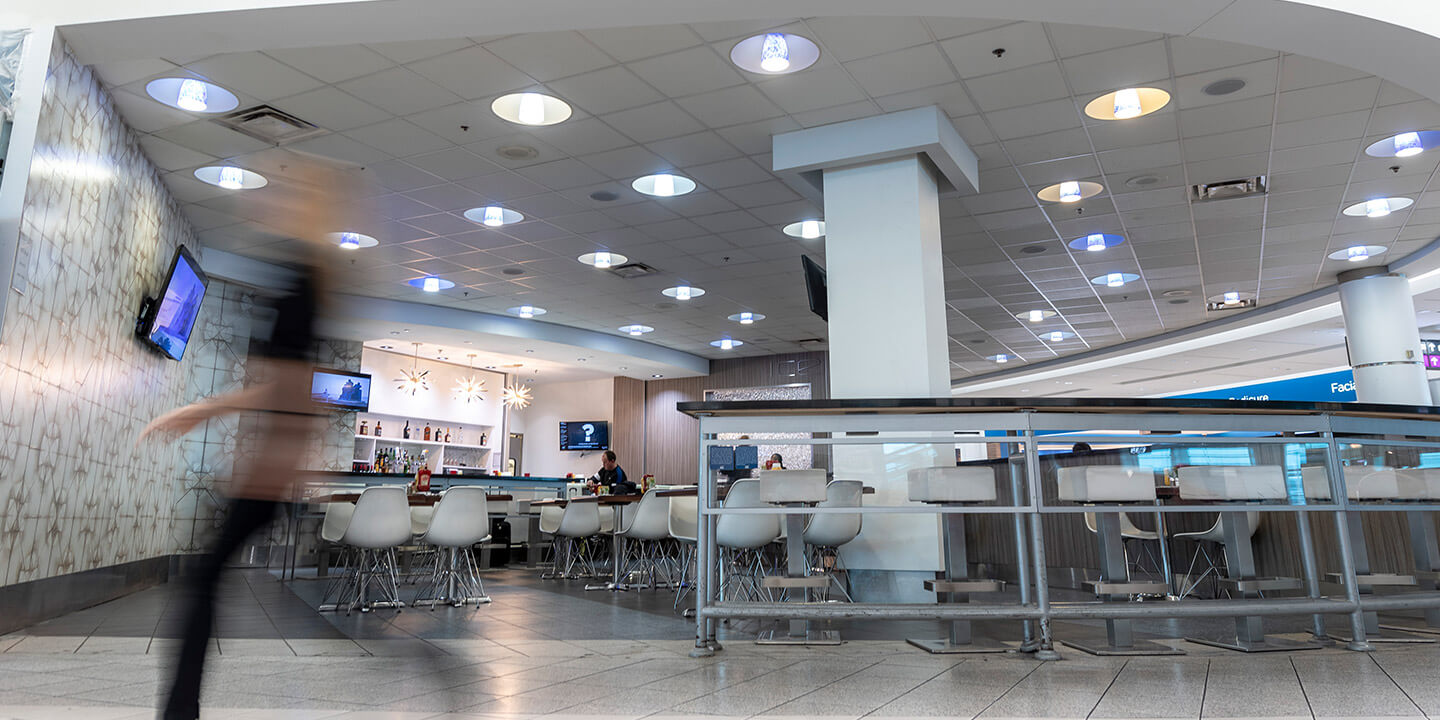 Ice Bar seating area with tables and chairs and high counter with stools