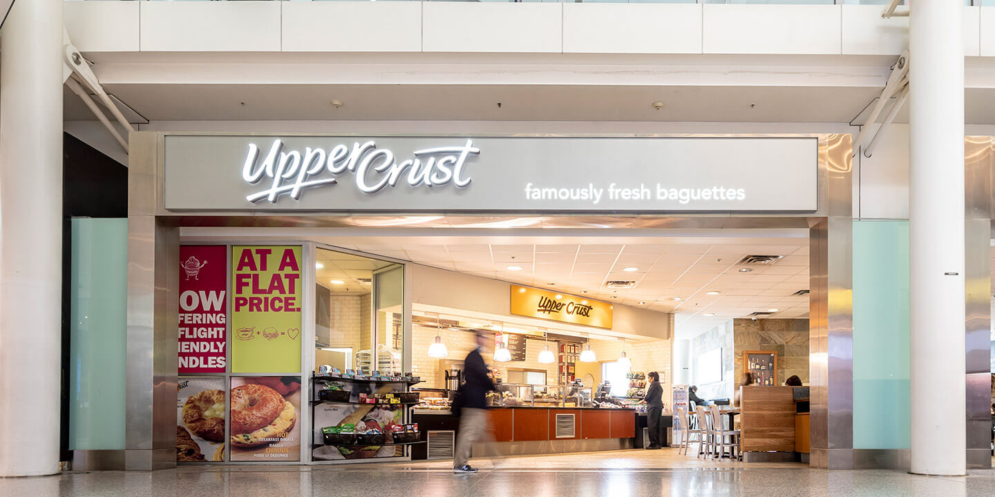 Outside view of Upper Crust ordering counter and some table seating 
