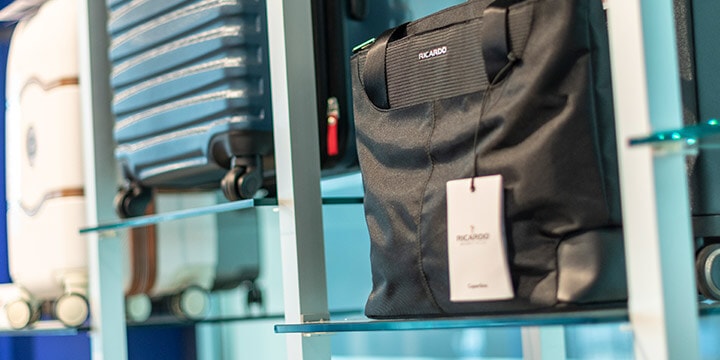 Wall display of hard and soft suitcases. 