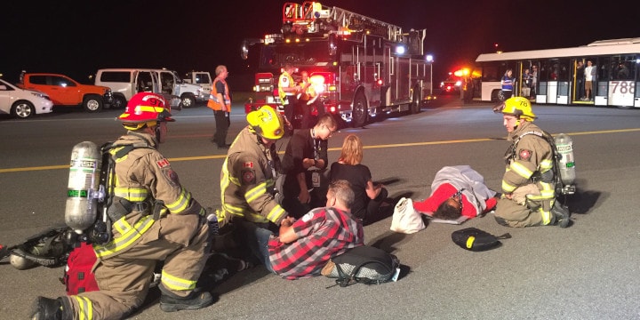 a group of firefighters attending to a person lying on the ground